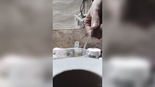 Boy close up Peeing on a cup, Trowing pee away then peeing again on the cup - 3 image