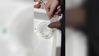 Boy close up Peeing on a cup, Trowing pee away then peeing again on the cup - 5 image