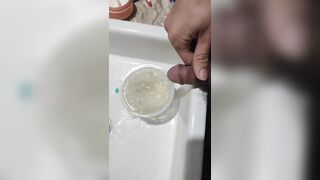 Boy close up Peeing on a cup, Trowing pee away then peeing again on the cup - 6 image