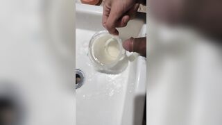 Boy close up Peeing on a cup, Trowing pee away then peeing again on the cup