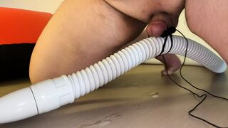 Small Penis With Vibrator Eggs Holding A Vacuum Hose - 1 image