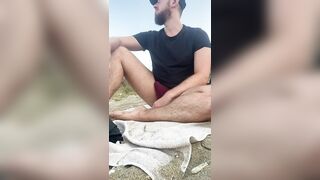 Playing on the beach in speedos. - 2 image