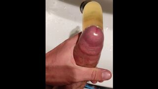 I piss in a condom while getting horny and I ejaculate in my piss with my big cock - 1 image