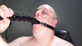 Deepthroating an 18 inch dildo with mouth gag ring - 1 image