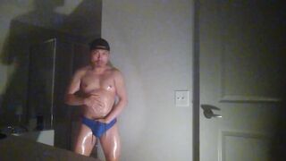 Oiled up and posing while wearing Speedos!