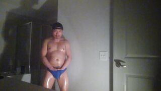 Oiled up and posing while wearing Speedos!