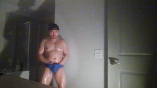 Oiled up and posing while wearing Speedos!