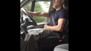 Muscular trucker jerks off and cums while driving - 1 image