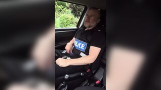 Muscular cop jerks off in police car beside busy road. - 1 image