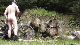 Muscle stud gets naked on a bike ride, flexes muscles lifts huge logs and cums (old vid)