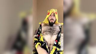 Bald bearded blue-eyed white otter in cute onesie pajamas strips down to tease very hairy ass with a gaming controller - 1 image
