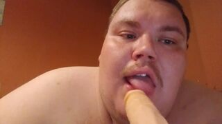 Fat man sucking a dildo - 1 image