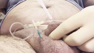 Inserting a large catheter into a small cock with big balls - 2 image