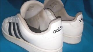 "A pair of white Adidas sneakers worn by a beautiful preppy girl." - 5 image