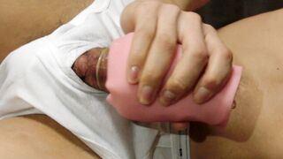 Wearing white briefs and shooting cum into a condom with a sex toy.