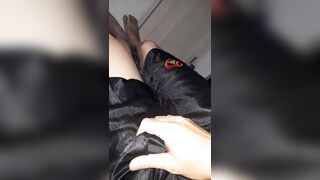 Pleasure wearing shiny slippery black shorts bulge