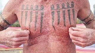 Playing with my nipples at the beach