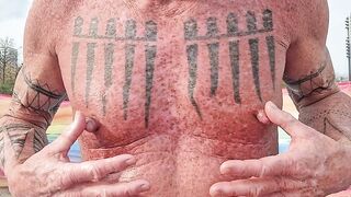 Playing with my nipples at the beach