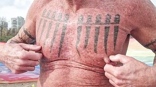 Playing with my nipples at the beach