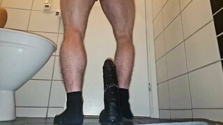 Muscular guy fucking a big black dildo