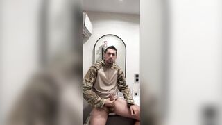 Military guy two hands jerks his meat