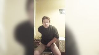 A tattooed gay man in glasses is riding a cucumber!