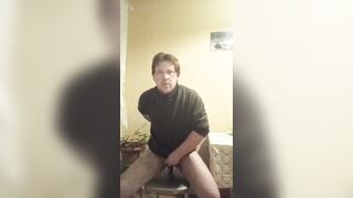 A tattooed gay man in glasses is riding a cucumber!