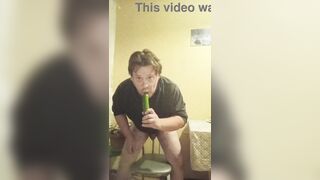 A tattooed gay man in glasses is riding a cucumber!